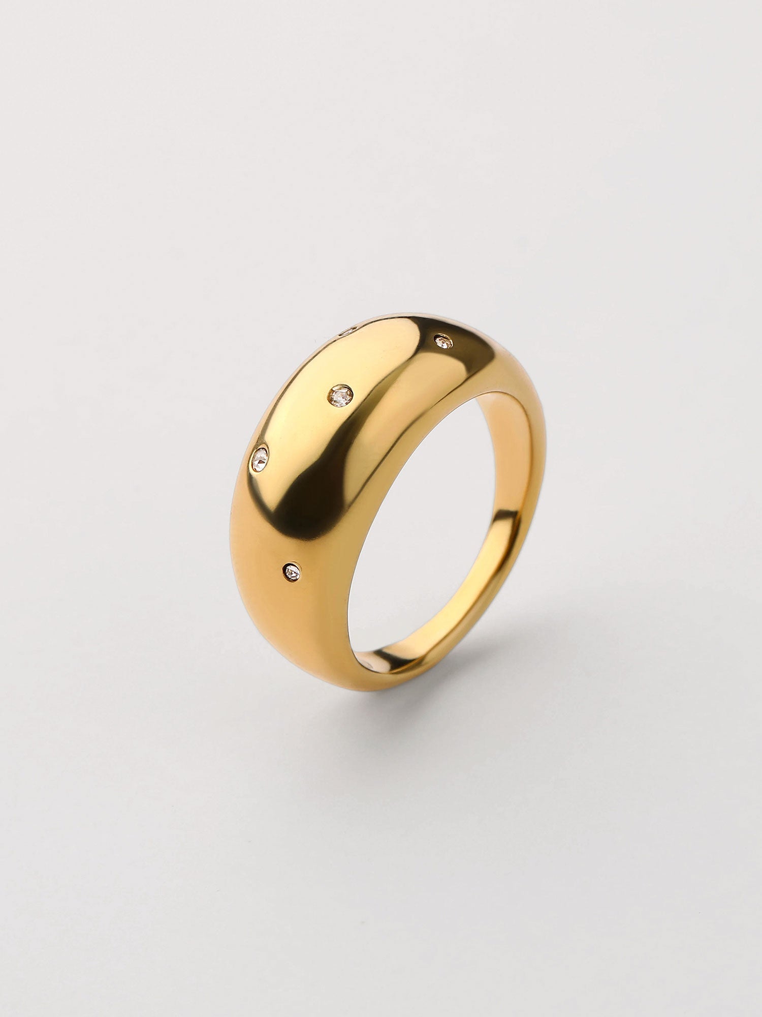 Anillo grueso dorado zirconias abierto