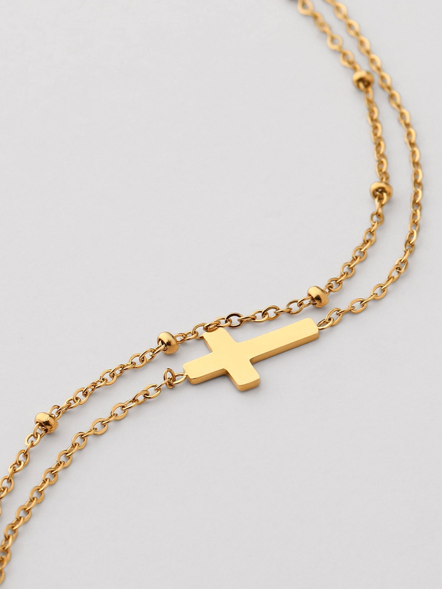 Pulsera cadena fina con cruz dorada
